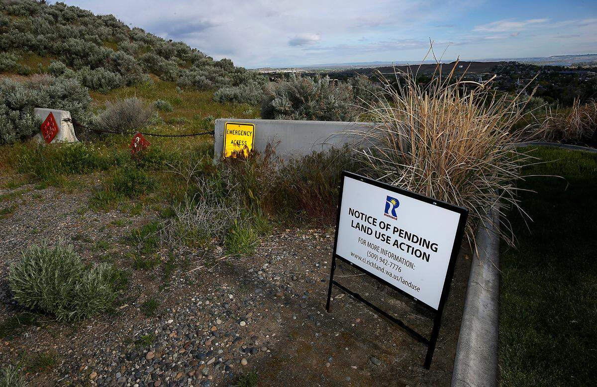A sign posted at the dead end of Meadow Hills Drive by the City of Richland notifies residents of a pending land use action in south Richland. A developer is proposing to build a condominium project of the nearby hillside.