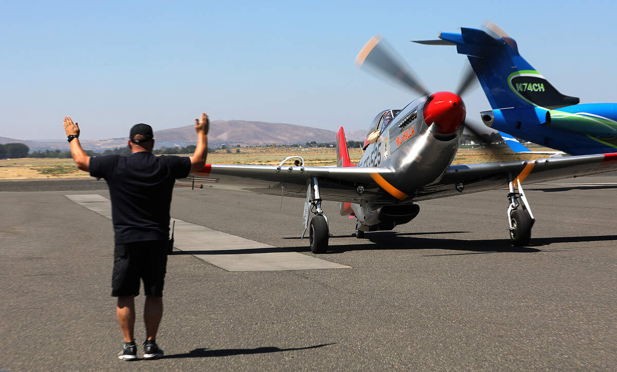 Pilot Greg Anders lands his WWII era P-51 Mustang “Val-Halla” at the Tri-Cities Airport in Pasco for his weekend performances at the STCU Over-The-River Air Show.