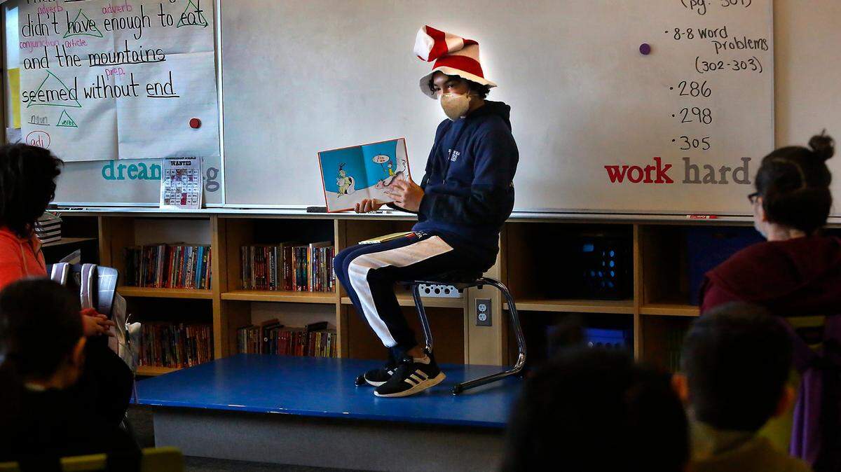 Diego Anguiano, an 8th-grade National Junior Honor Society student at Highlands Middle School, reads Dr. Seuss’s book Green Eggs and Ham to students during the recent annual Read Across America event.