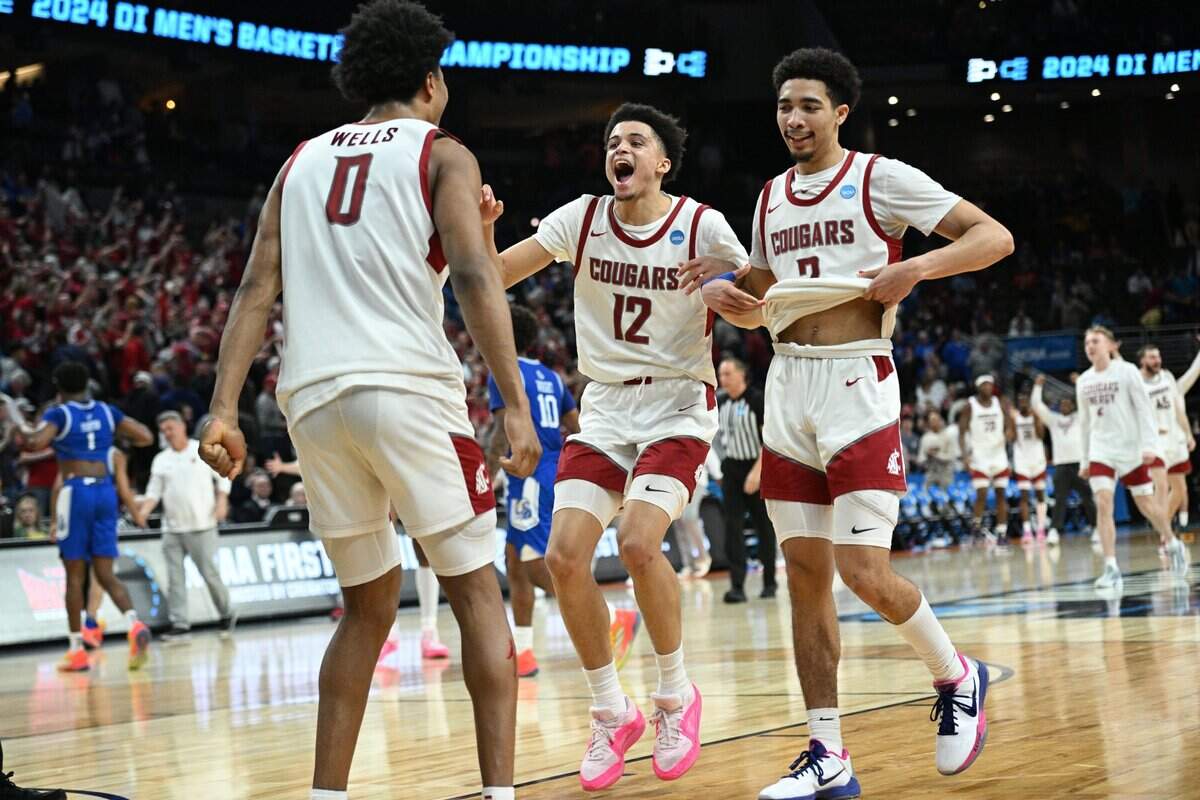 Mar 21, 2024; Omaha, NE, USA; Washington State Cougars forward Jaylen Wells (0) and guard Isaiah Watts (12) and guard Myles Rice (2) celebrate after defeating the Drake Bulldogs in the first round of the 2024 NCAA Tournament at CHI Health Center Omaha. Mandatory Credit: Steven Branscombe-USA TODAY Sports