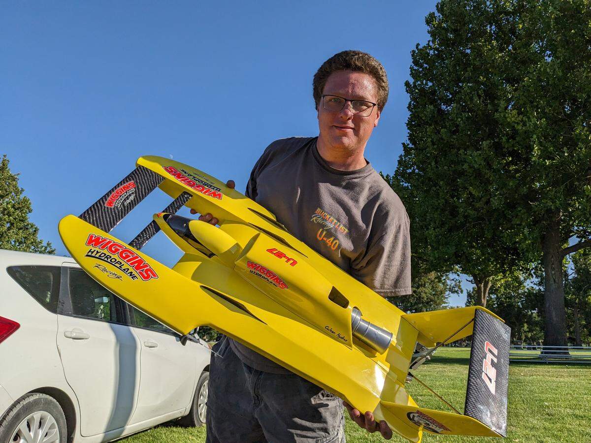 Jason Colean of Pasco shows his one-tenth scale yellow RC hydroplane. Dozens of super fans and enthusiasts of the annual Water Follies Columbia Cup races gathered early to prep for the weekend races.