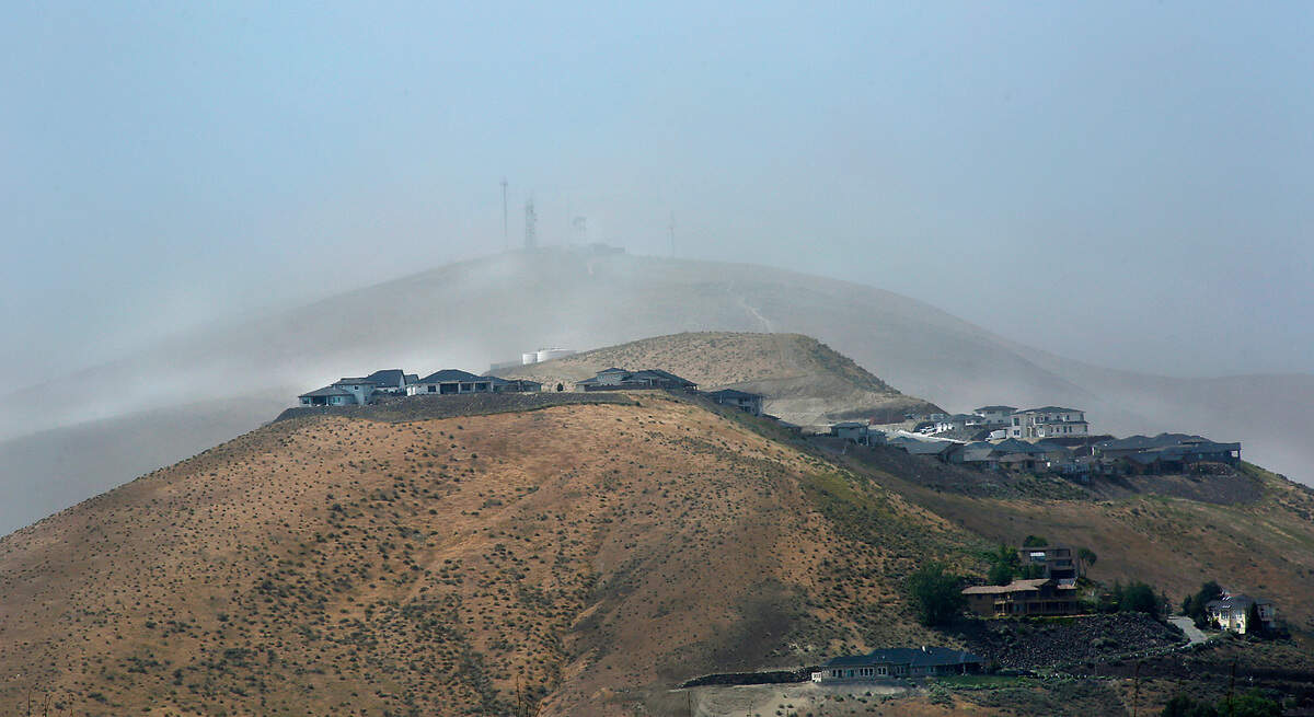 Clouds of windblown dust in May 2021 roar over the houses built on the hilltop overlooking the Meadows Springs area in south Richland.