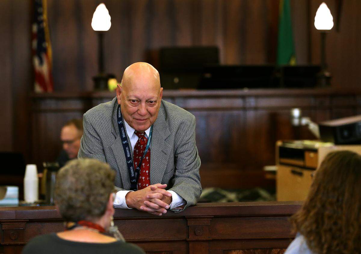Dave Corkrum, chief criminal deputy prosecutor in Franklin County, talks in October 2024 with family members of fatal stabbing victim Richard Lenhart before the start of a sanity hearing for a murder suspect.