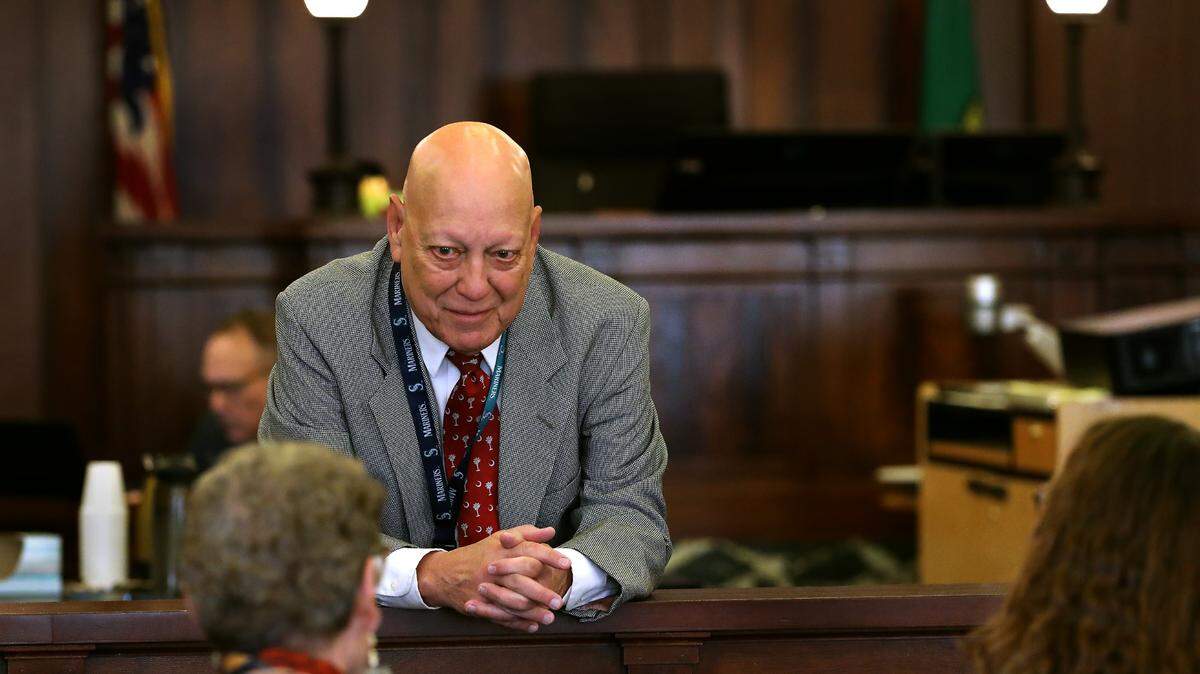 Dave Corkrum, chief criminal deputy prosecutor in Franklin County, talks in October 2024 with family members of fatal stabbing victim Richard Lenhart before the start of a sanity hearing for a murder suspect.
