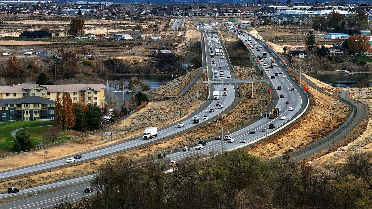 Traffic flows on Interstate 182 across the twin bridges over the Columbia River between Richland and Pasco.