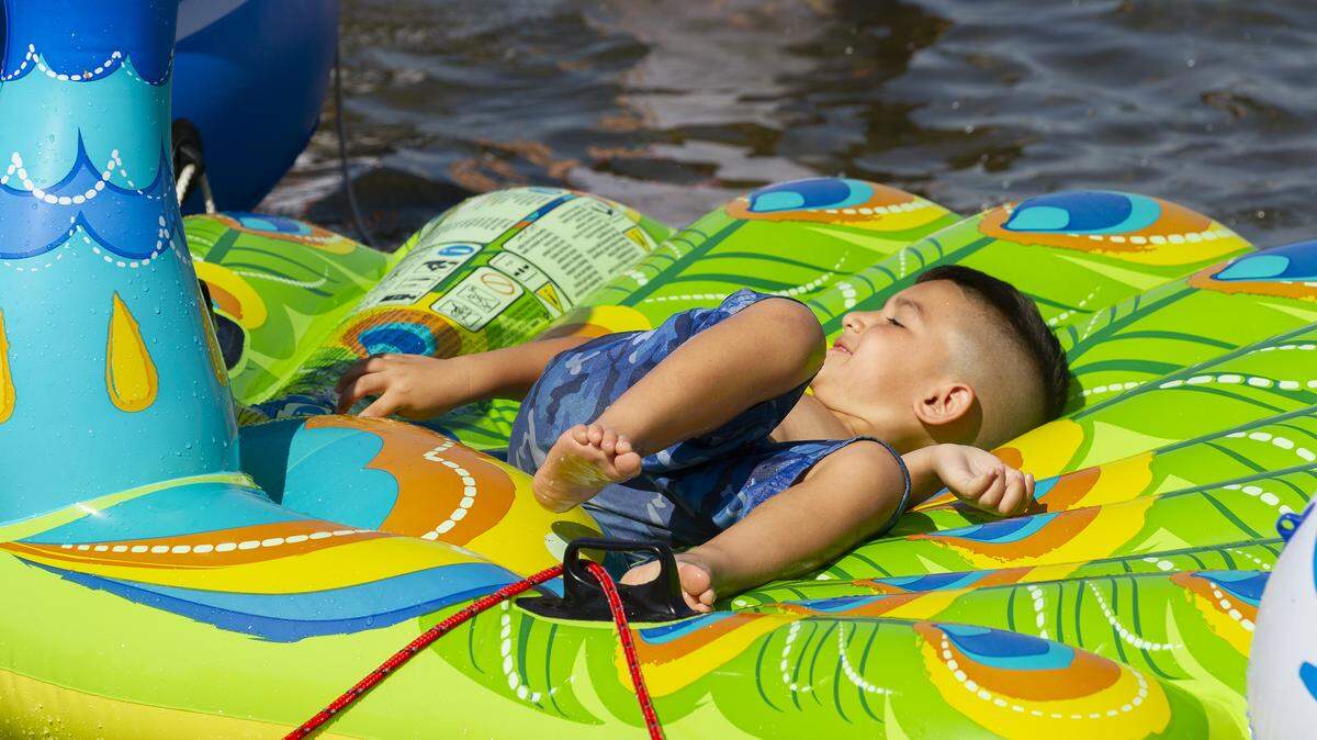 Alvin Gonzalez lays on a peacock inflatable in the Columbia River to stay cool on a hot Friday afternoon during the 2018 HAPO Columbia Cup & Over the River Air Show. 
Saturday and Sunday’s high is 100 degrees
Alvin was accompanied by his mother Yesenia Gonzalez of Richland.