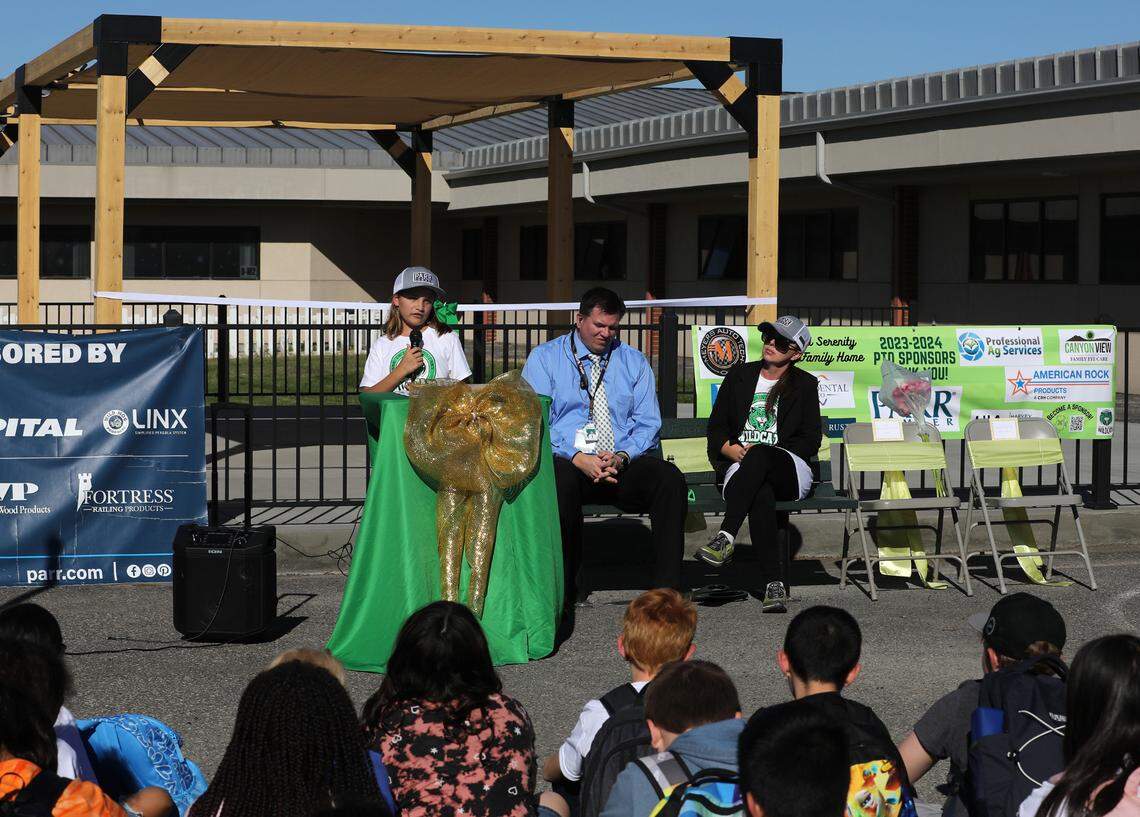 Genie Hernandez, a Mark Twain fifth-grade student, takes part in the ribbon cutting ceremony of her dream that became reality, an outdoor shaded classroom area in the courtyard of the Pasco elementary school on North Road 40. The project was a collaboration between the Mark Twain PTO and donations from community businesses. To her right are: interim principal Eric Christensen and PTO president Carlee Black Esparza.
