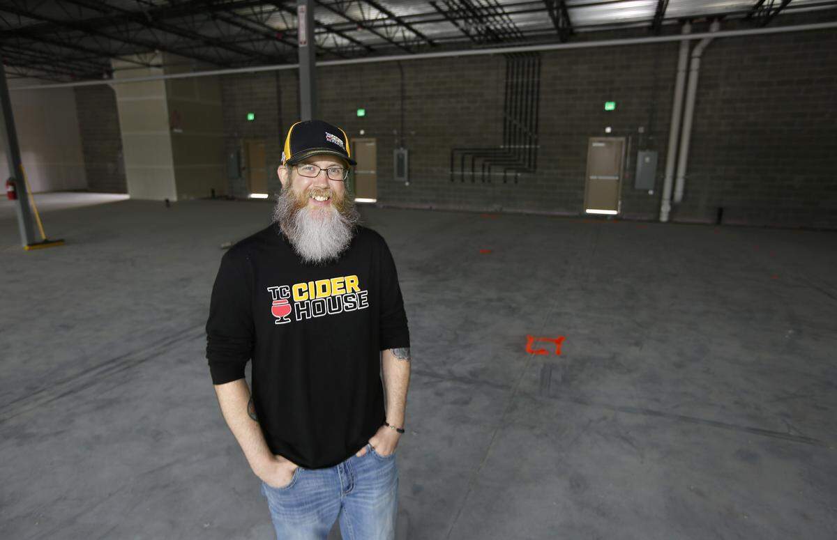 Nate Steele stands near paint marks on the concrete floor indicating the approximate location of utilities for his new business called the Tri-Cities Cider House at 1082 George Washington Way in Richland. His new drinking establishment scheduled to open this summer will feature a variety of ciders. Watch a video at: tricityherald.com/videos