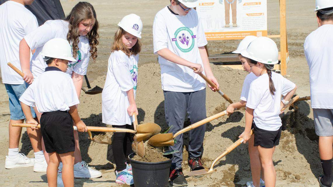 Future students of Pasco’s third comprehensive school district flip soil on the first tree sapling to be planted at the site. When it opens in fall 2025, the new school will serve 2,000 students living in the northwest neighborhoods of the Pasco School District. 