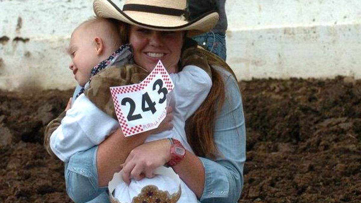 Rascal Rodeo president and founder Ann-Erica Whitemarsh gets a grateful hug on rodeo day.
