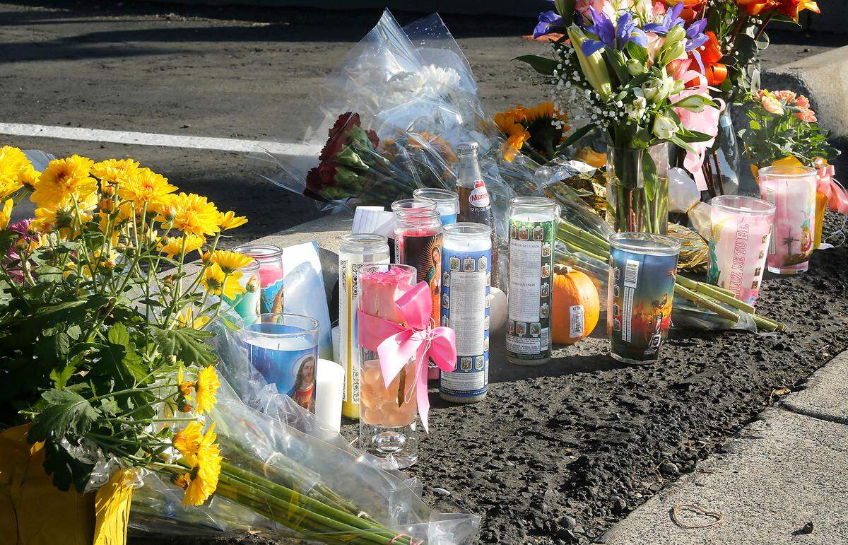 A memorial of flowers, candles and other items was started near where Ashley Guevara, 21, died after falling from a Toyota Camry at Clearwater Avenue and Morain Street in Kennewick.