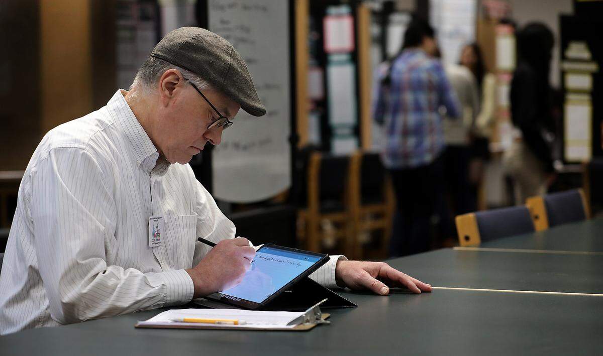 Scott Hudson, a WSU Tri-Cities professor, enters notes after judging an entry at the 71st annual Mid-Columbia Regional Science & Engineering Fair held Thursday morning at the WSU Tri-Cities campus in Richland.