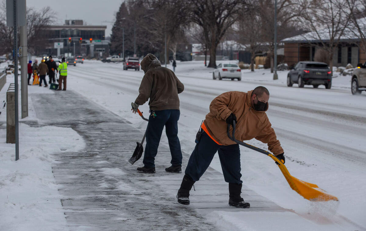 Workers from Columbia Industries clear the sidewalks outside of the Richland Federal Building and U.S. Courthouse along Jadwin Avenue on Monday morning.