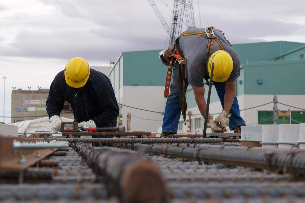 Employees work on embeds installed in a rebar curtain for the Effluent Management Facility at the Hanford vitrification plant.