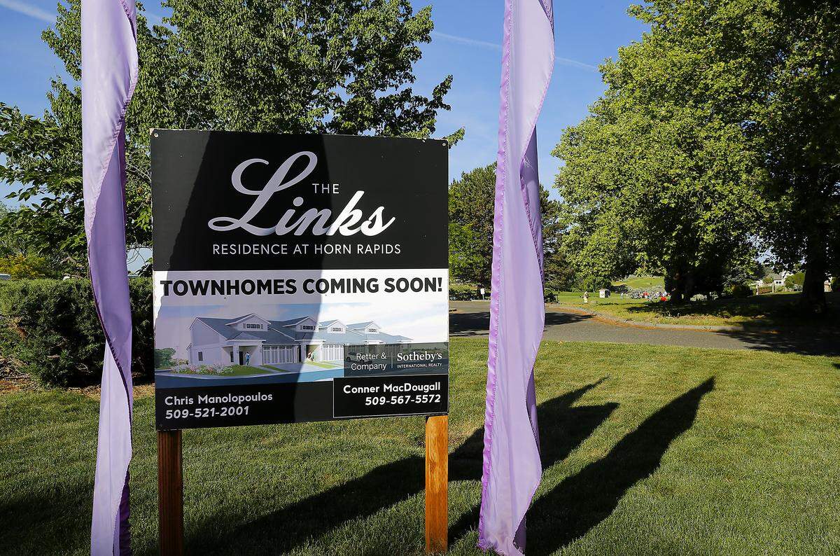 A sign advertises for The Links Residence at Horn Rapids townhomes development in Richland.
