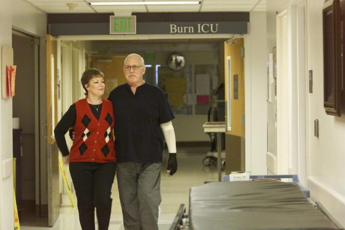 Connie and Bob Koch leave the burn intensive care unit at Harborview Medical Center in Seattle after a quick visit between Bobs rehabilitation sessions.