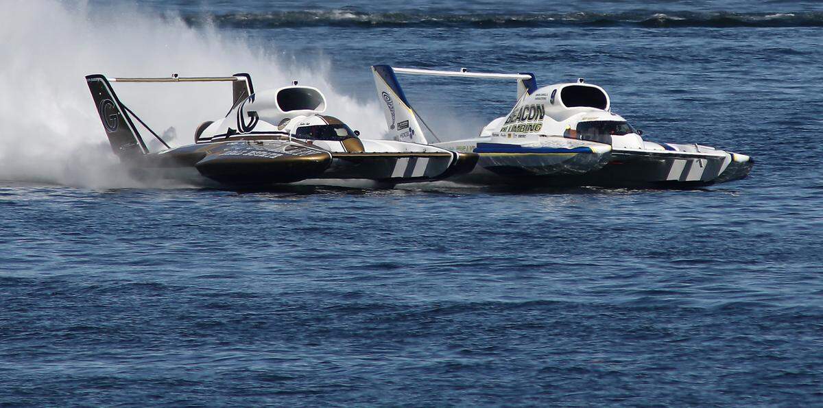 Corey Peabody in the U-9 Miss Beacon Plumbing and Andrew Tate in the U-91 Goodman Real Estate unlimited hydroplan are deck-to-deck as they race in Heat 3A Sunday on the Columbia River. Peabody was the winner of the heat.