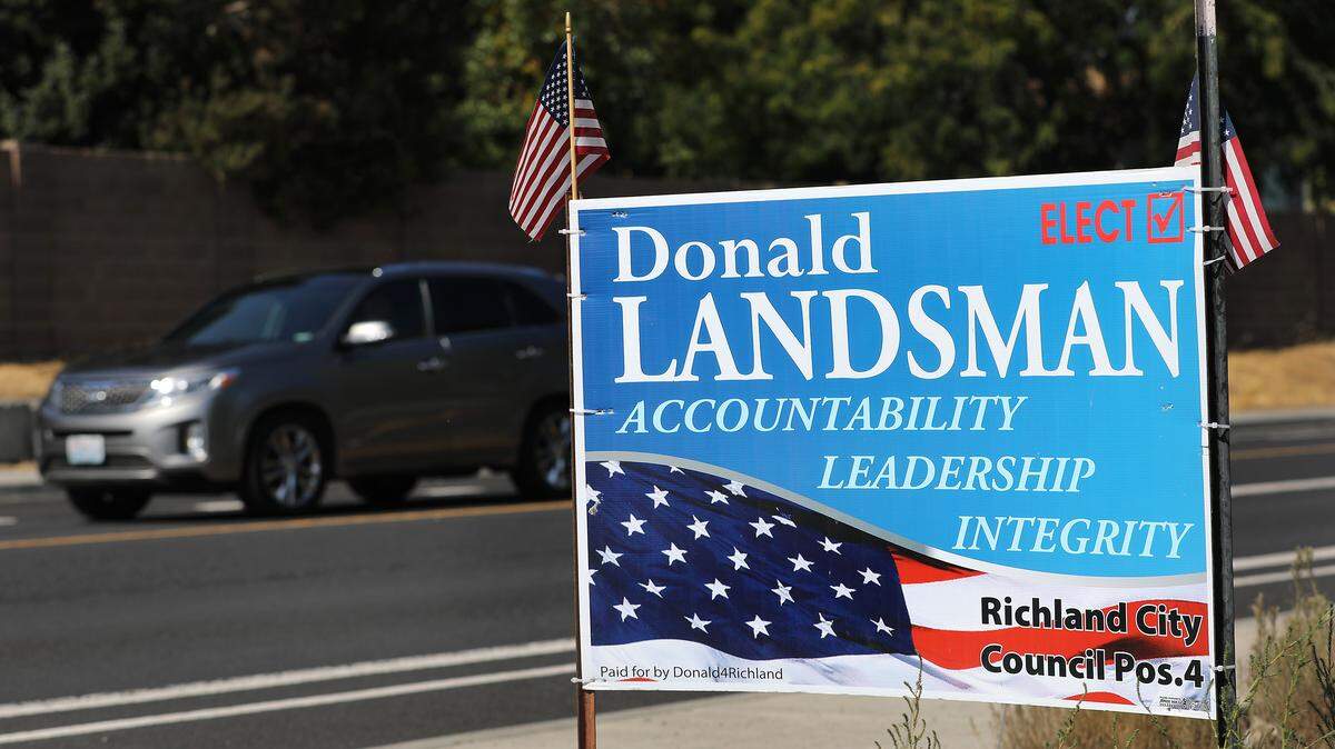 City council campaign signs for Donald Landsman remain posted along Leslie Road and elsewhere in Richland even after his death in August. His name will be on the November ballot.