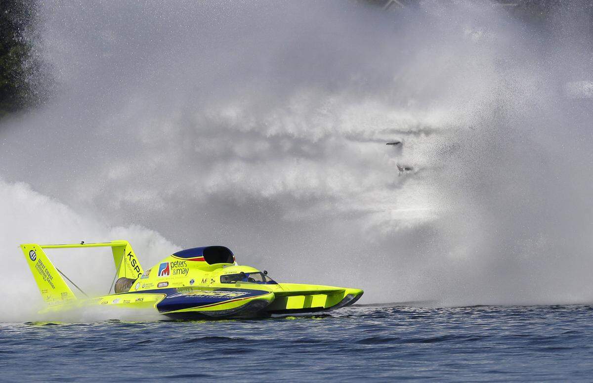 The Spirit of Qatar H1 Unlimited Hydroplane boat goes sideways, at upper right, in the spray next to the yellow Peters & May boat during a preliminary heat Aug. 3, 2014, in Seattle. The races that are part of Seattle’s annual Seafair weekend have been canceled because of the ongoing COVID-19 pandemic.