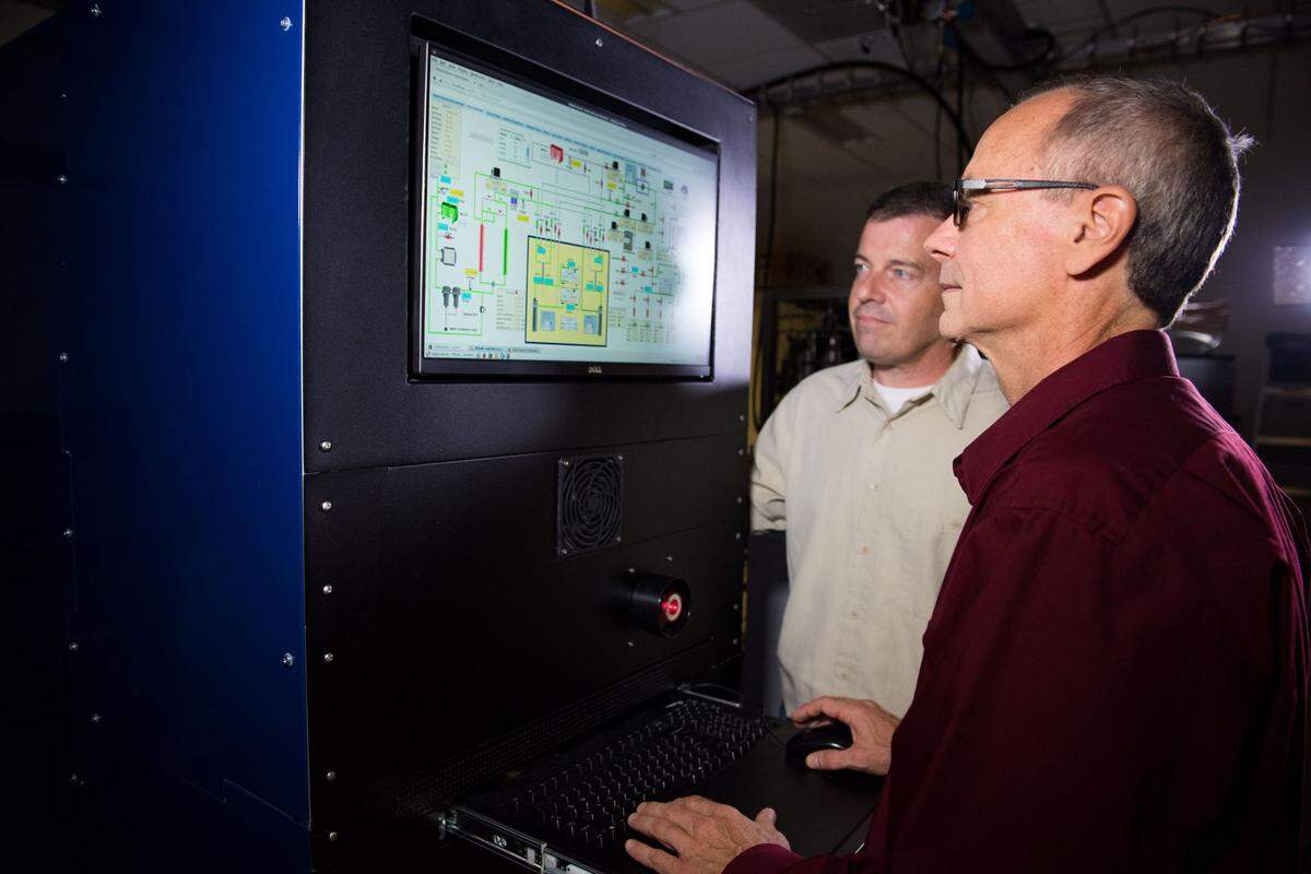 PNNL researchers Jim Hayes (front) and Mark Panisko are developing improved methods and instruments to measure radioactive xenon concentrations in the atmosphere for the purpose of detecting nuclear explosion activity and treaty monitoring.