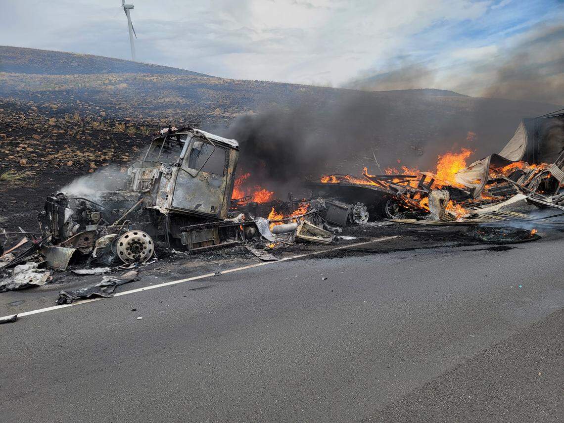 A semi truck and trailer caught on fire Monday, igniting a brush fire that shut down travel on I-90 until 7 p.m.