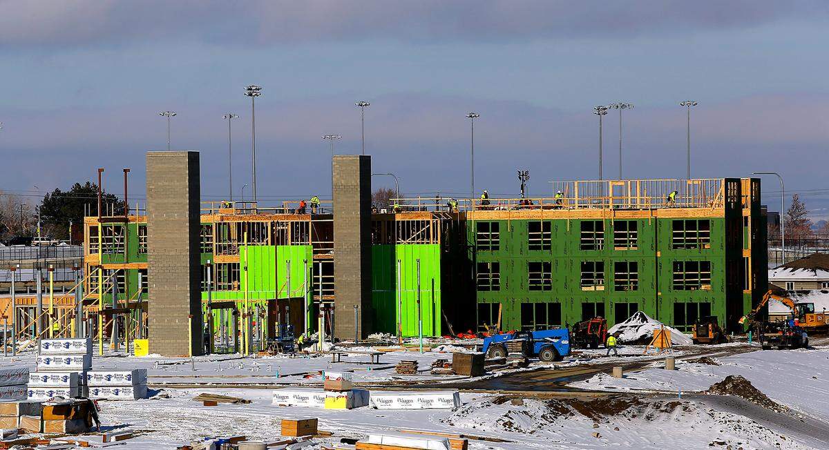 Two elevator shafts rise into the sky as construction workers build the first section of The Kennewick Retirement Residence, a four-story independent living retirement community featuring 149 suites in Kennewick.