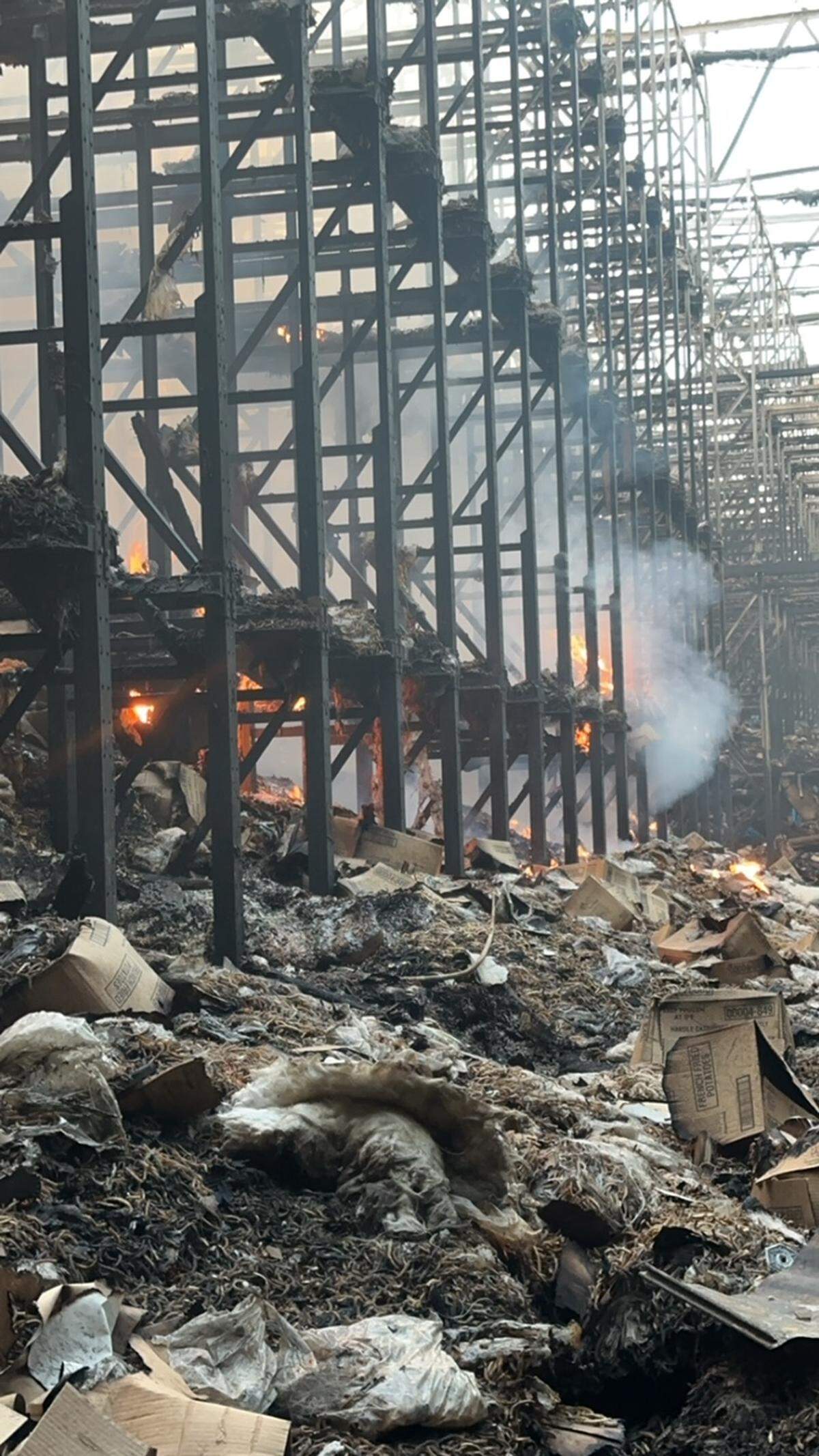 A fire continued burn three weeks after it started at the Kennewick Lineage cold storage warehouse in Finley.