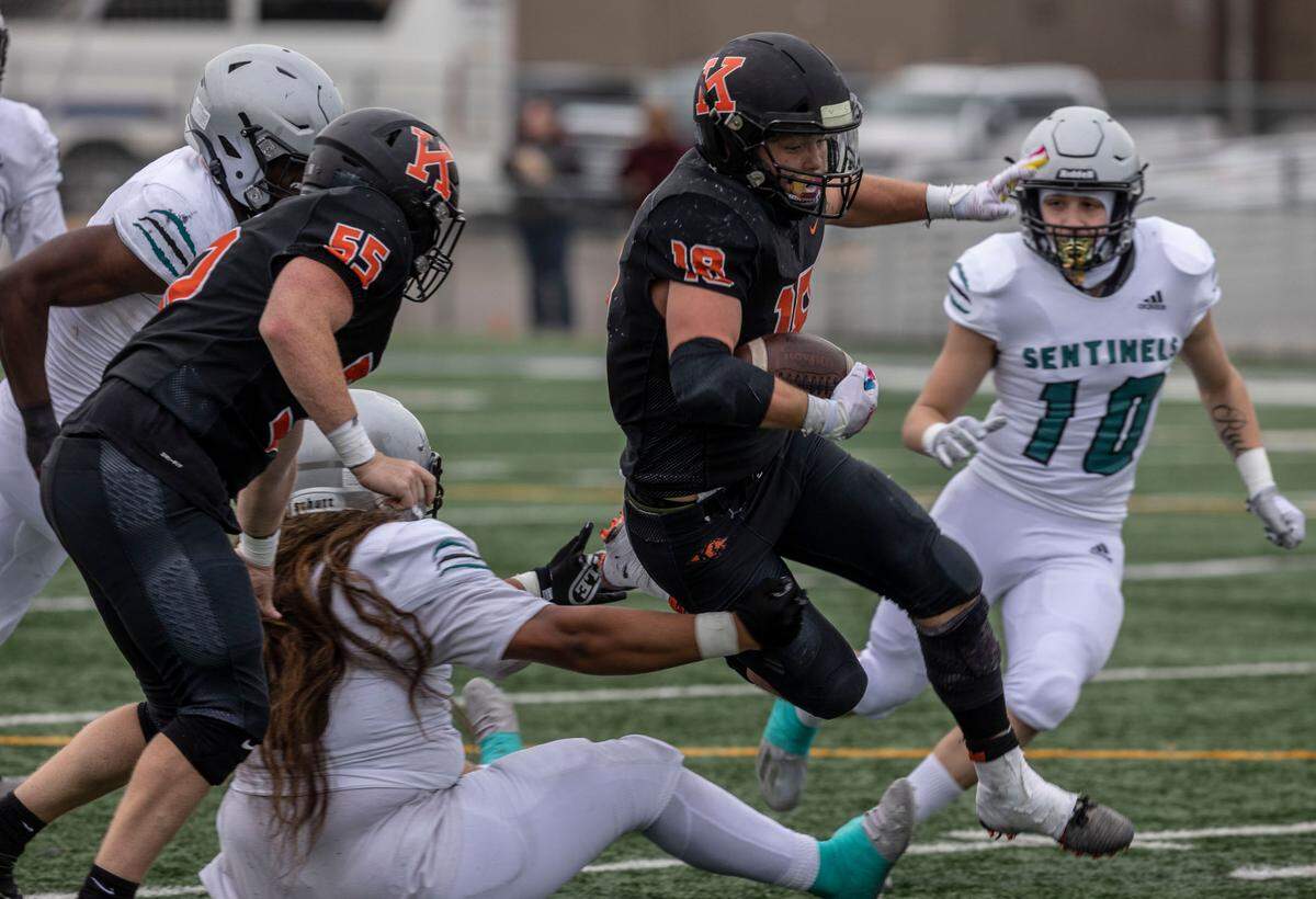 Kennewick Lions senior Myles Mayovsky (18) carried the football 28 times for 132 yards and a touchdown to help push his team into the state playoffs. This file photo is from a previus playoff game in Kennewick.