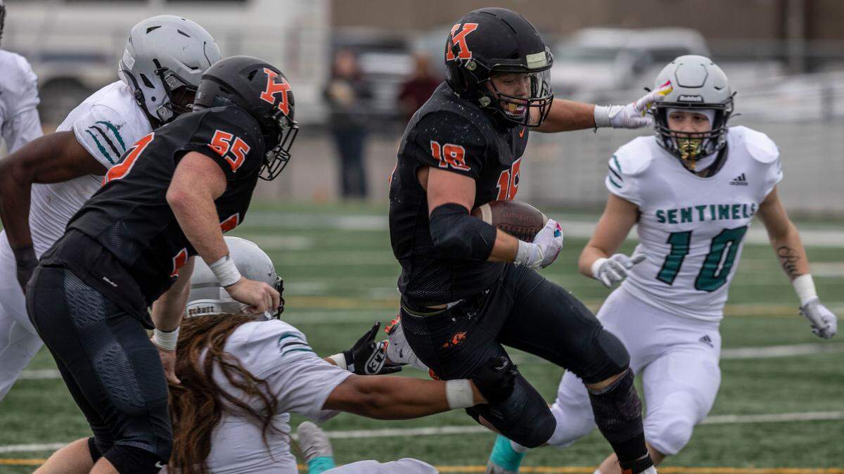 Kennewick Lions senior Myles Mayovsky (18) carried the football 28 times for 132 yards and a touchdown to help push his team into the state playoffs. This photo is from a previous playoff game in Kennewick.