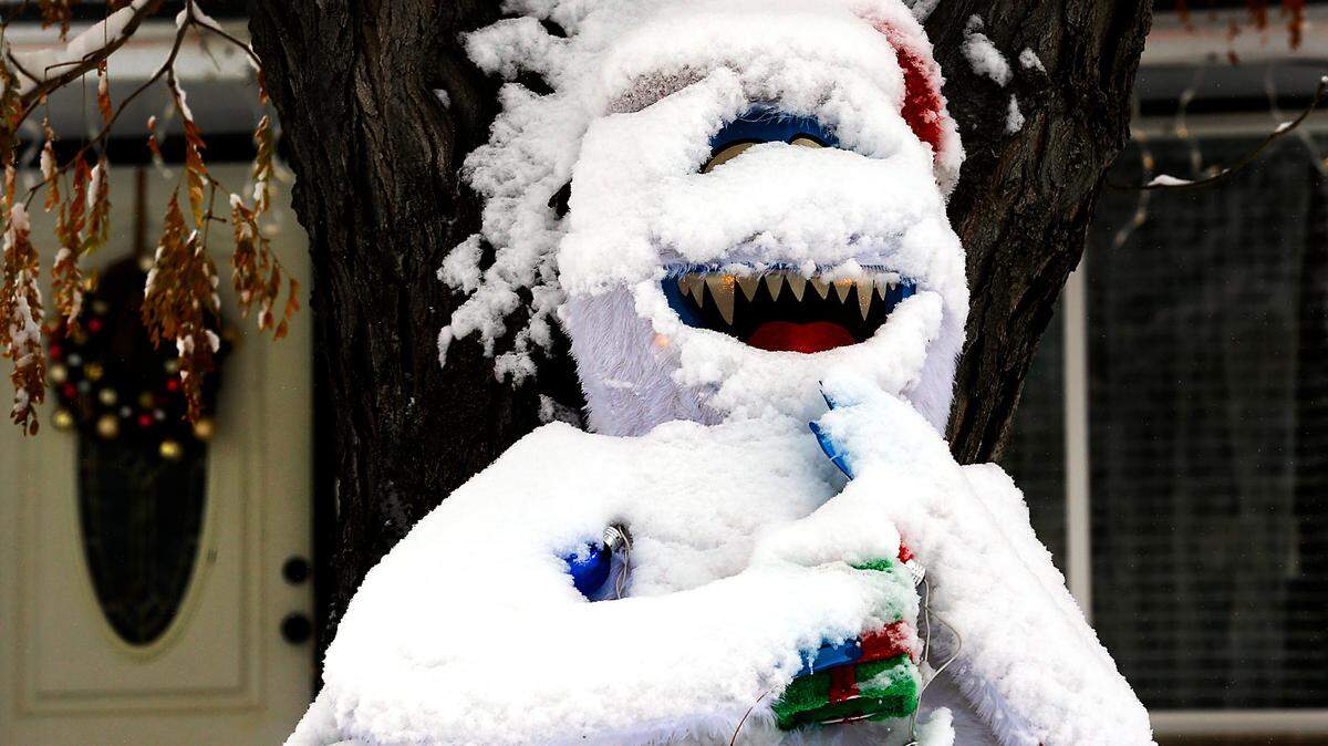 A layer of snow adds an element of realism last year to an abominable snowman Christmas decoration in the front yard of a home on South Kellogg Street near West Fifth Avenue in Kennewick.