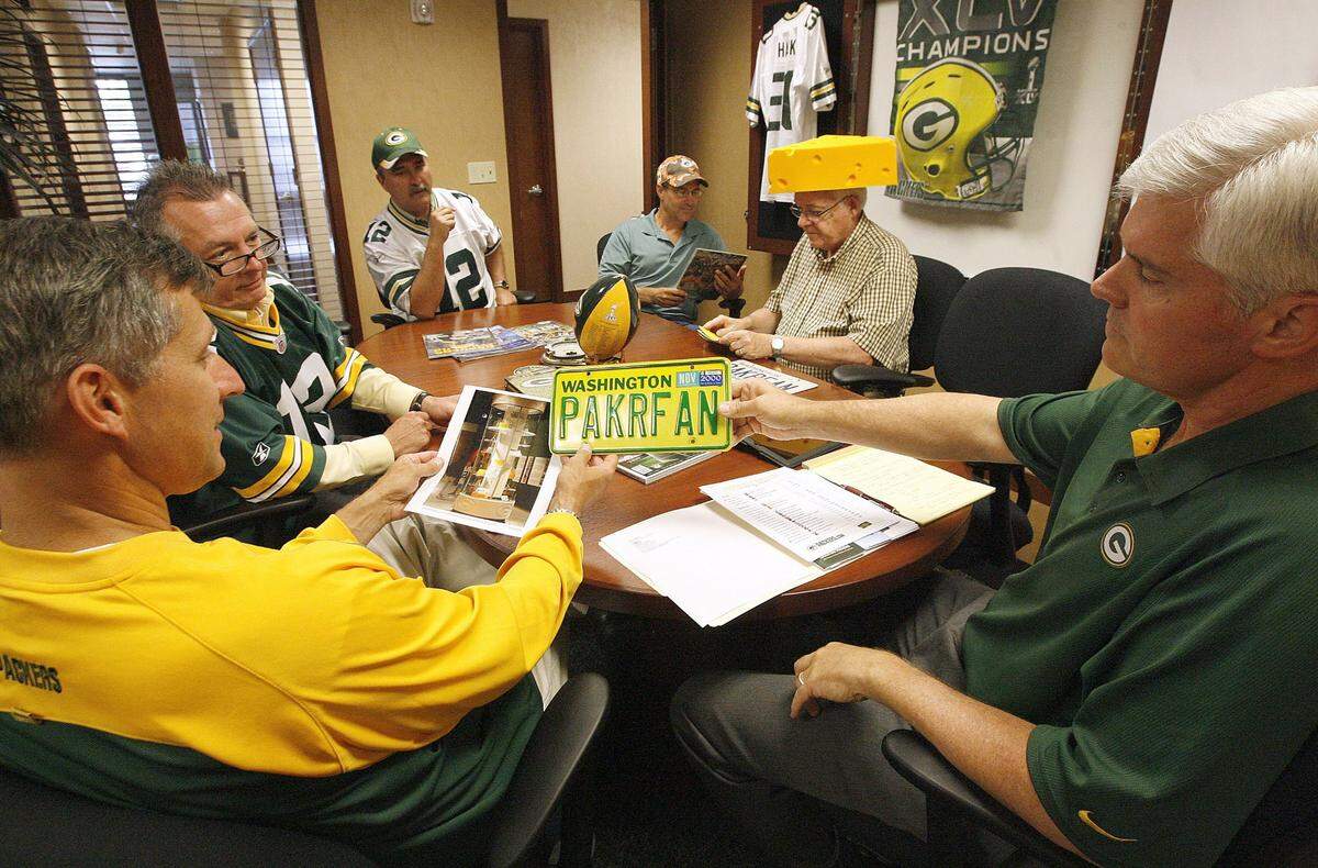 Brad Fisher, right, waited almost 30 years to become a Green Bay Packers season-ticket holder. His friends went to the games he could not attend.