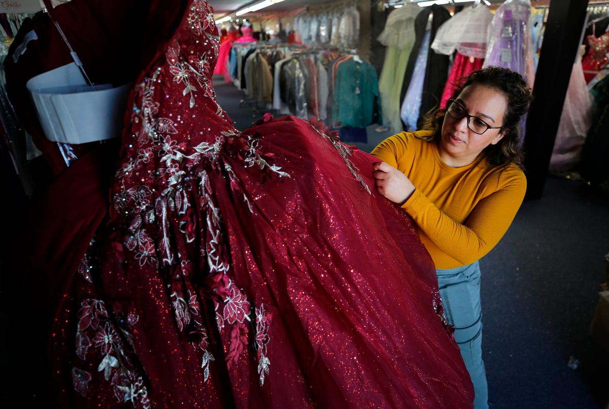 Ana Orozco, manager at Llane’s Boutique in downtown Pasco, steams away wrinkles from a formal gown recently. She had mixed feelings about how she decided on who to vote for in the recent presidential election. She chose Trump because of the economy.