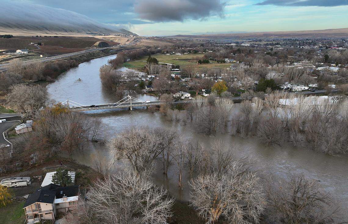 Traffic crosses the bridge over the swollen Yakima River off Interstate 82 at Benton City.