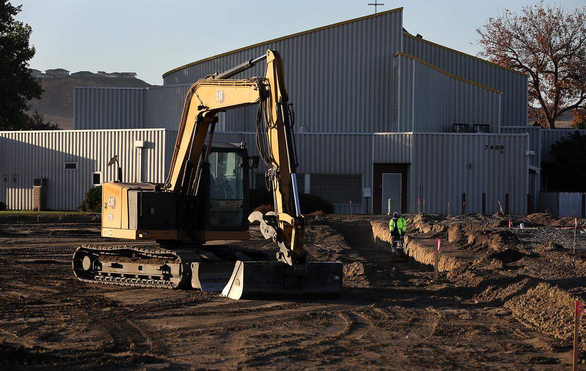 A construction worker compacts the dirt in a trench for the foundation of the new Clearwater Lofts construction project at 7275 W. Clearwater Ave. in Kennewick. The building will offer residential and commerical space.