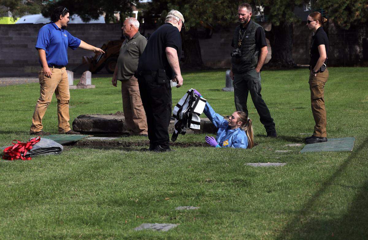 A member of the Benton County Coroner’s Office helps with the exhumation of an unidentified woman buried in 1986 in Richland.