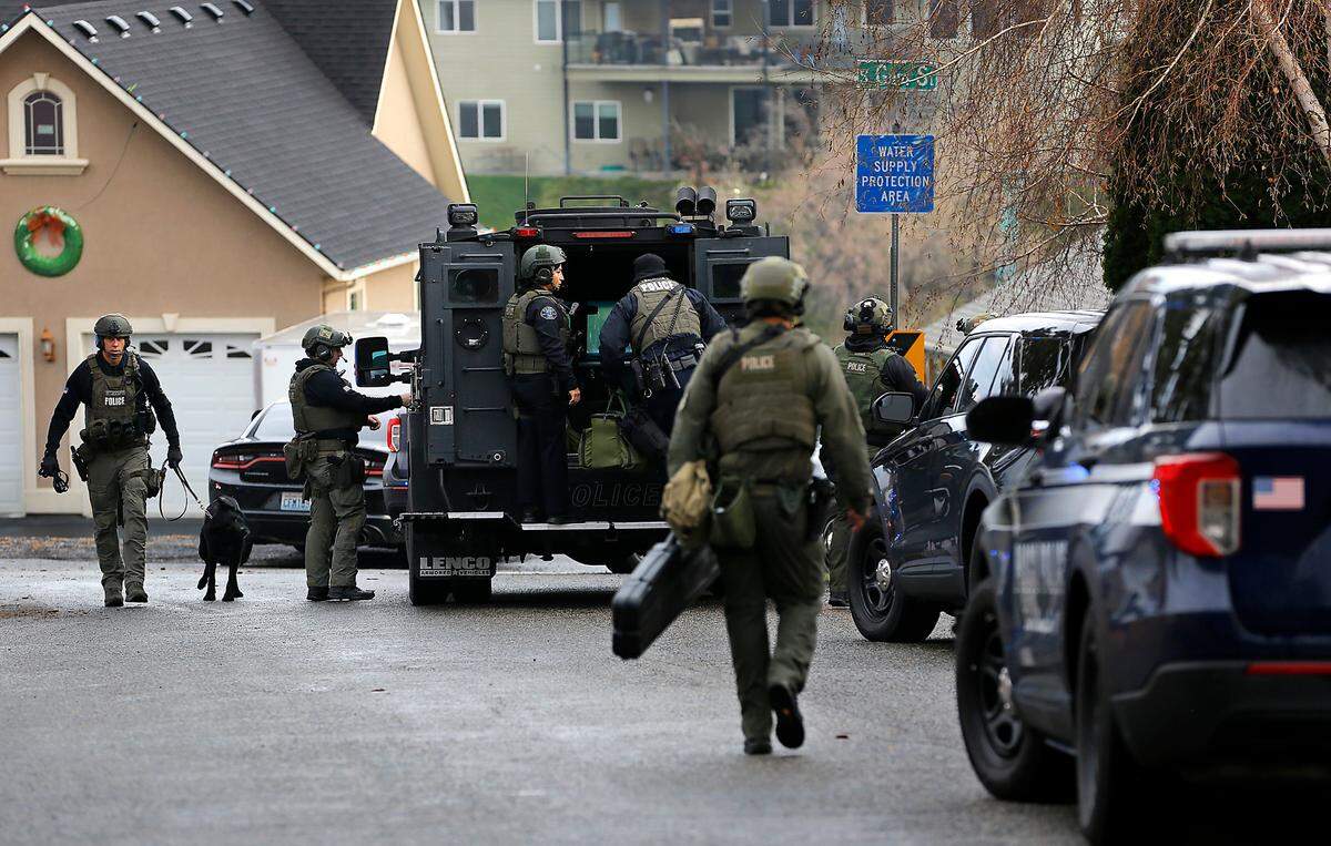 Members of the Tri-Cities Regional SWAT team congregate after detectives encountered Kennewick murder suspect Adam P. Klei.