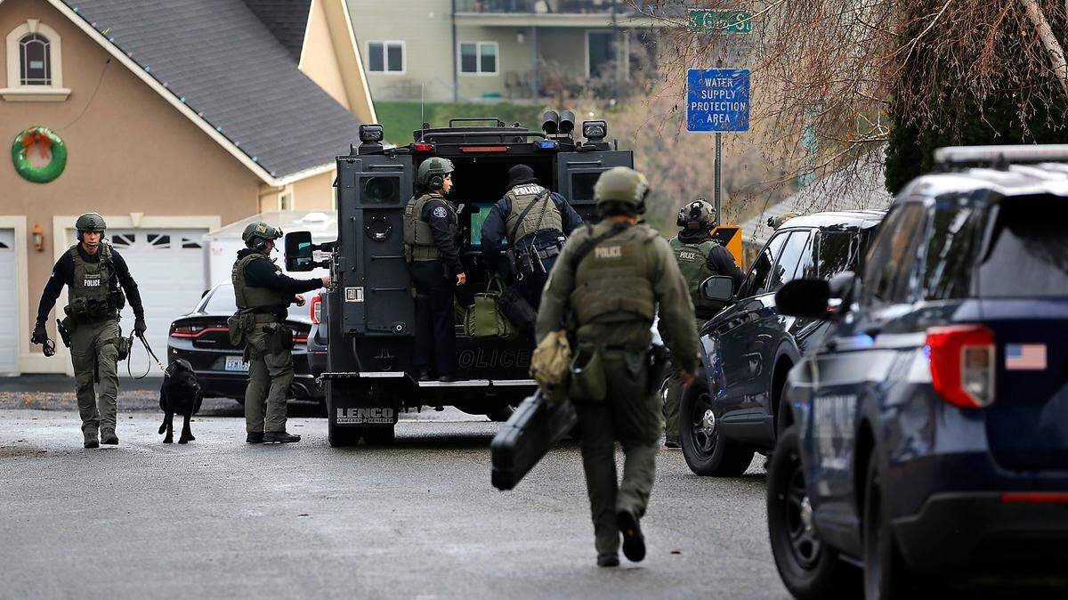 Members of the Tri-Cities Regional SWAT team congregate after detectives encountered Kennewick murder suspect Adam P. Klei just south of East 44th Avenue and South Gum Street in Kennewick. Investigators say Klei killed his brother in law Travis M. Kitchen after a brief confrontation.