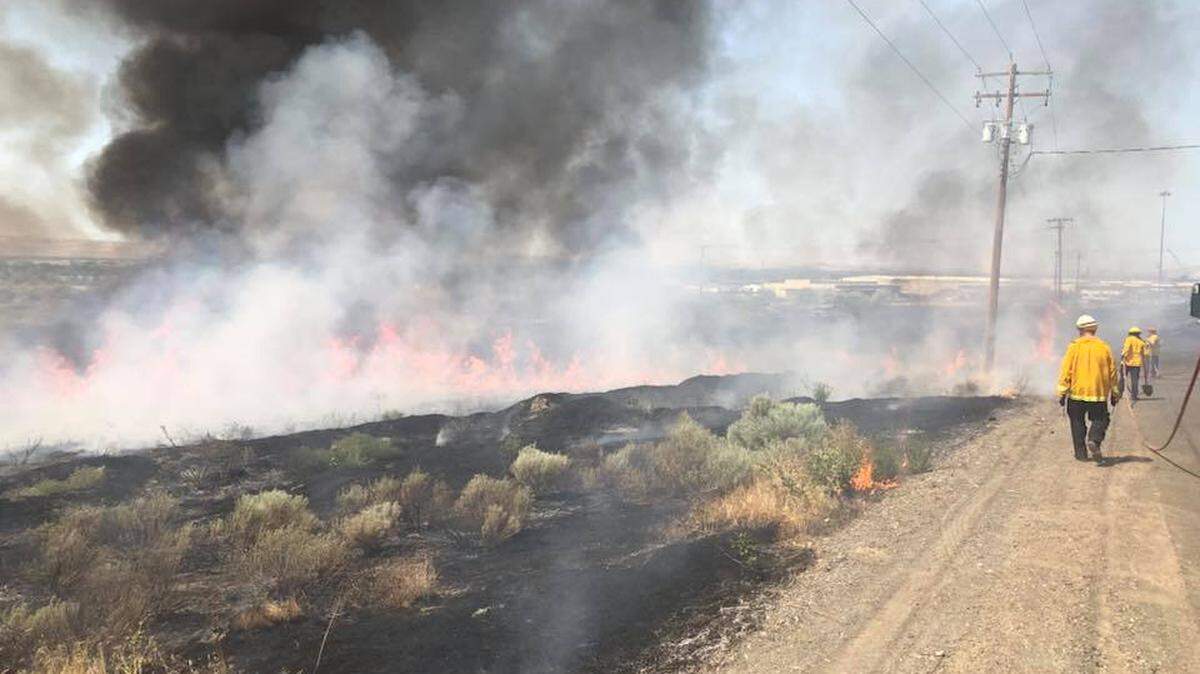 A fire burning near Sacajawea State Park in Pasco is sending up a column of smoke visible from across the river.