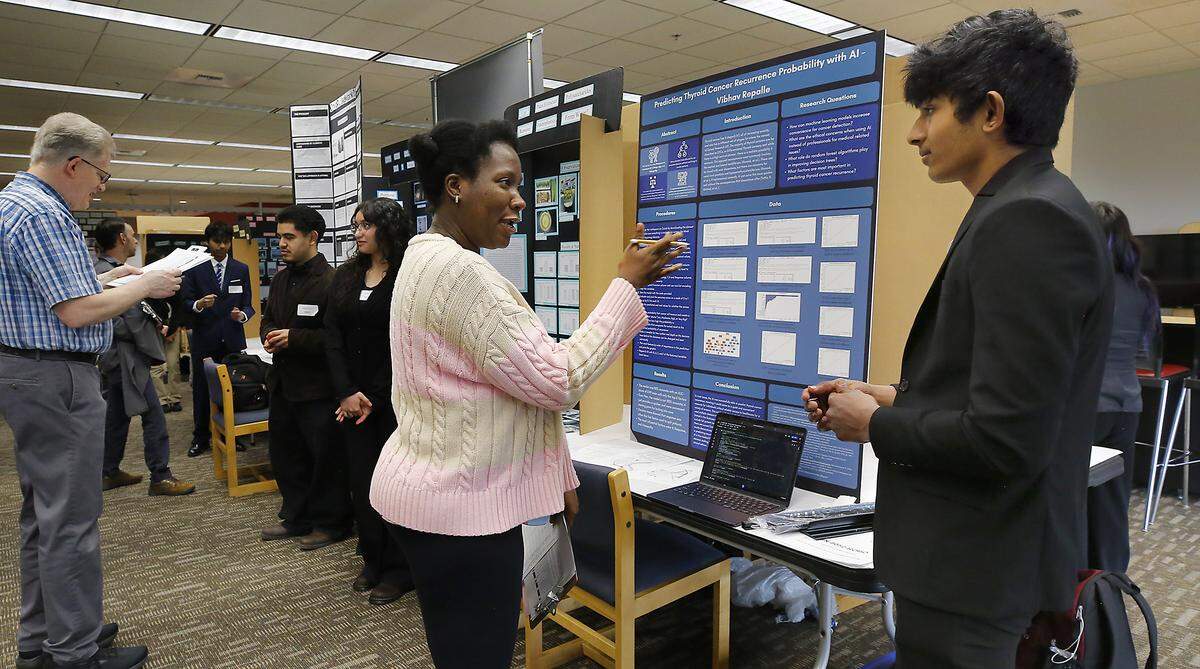 Hanford High junior Vibhav Repalle answers questions from judge Mavis Boamah-Agyemang, a PNNL scientist, about his project entered into the 71st annual Mid-Columbia Regional Science & Engineering Fair held at the WSU Tri-Cities campus in Richland. Repalle entry was titled: Predicting Thyroid Cancer Recurrence Probability with AI. 