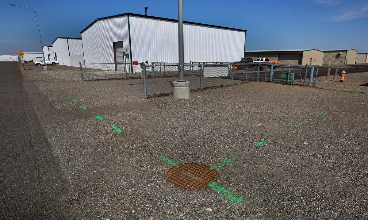 Green paint indicates sewer lines running underground parallel to Butler Loop at the Port of Benton’s Richland Airport.