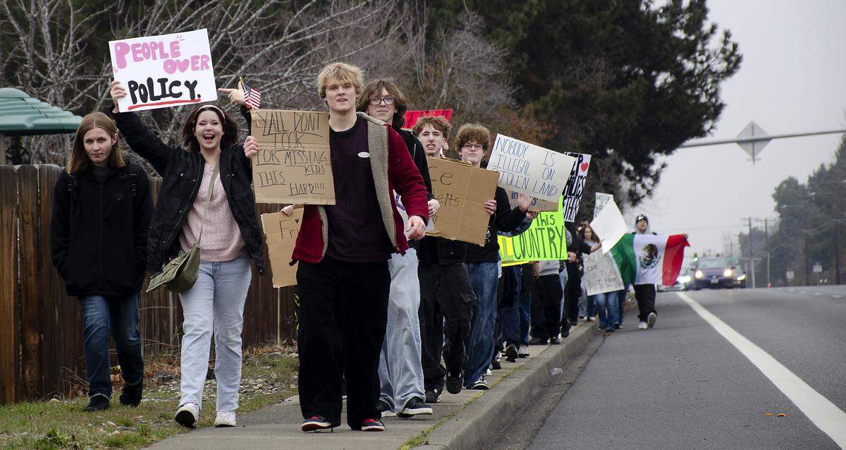 Students from Hanford High School in Richland participate in Friday's walkouts and marches on public sidewalks to protest federal ICE immigration enforcement. They walked from the school to John Dam Plaza.