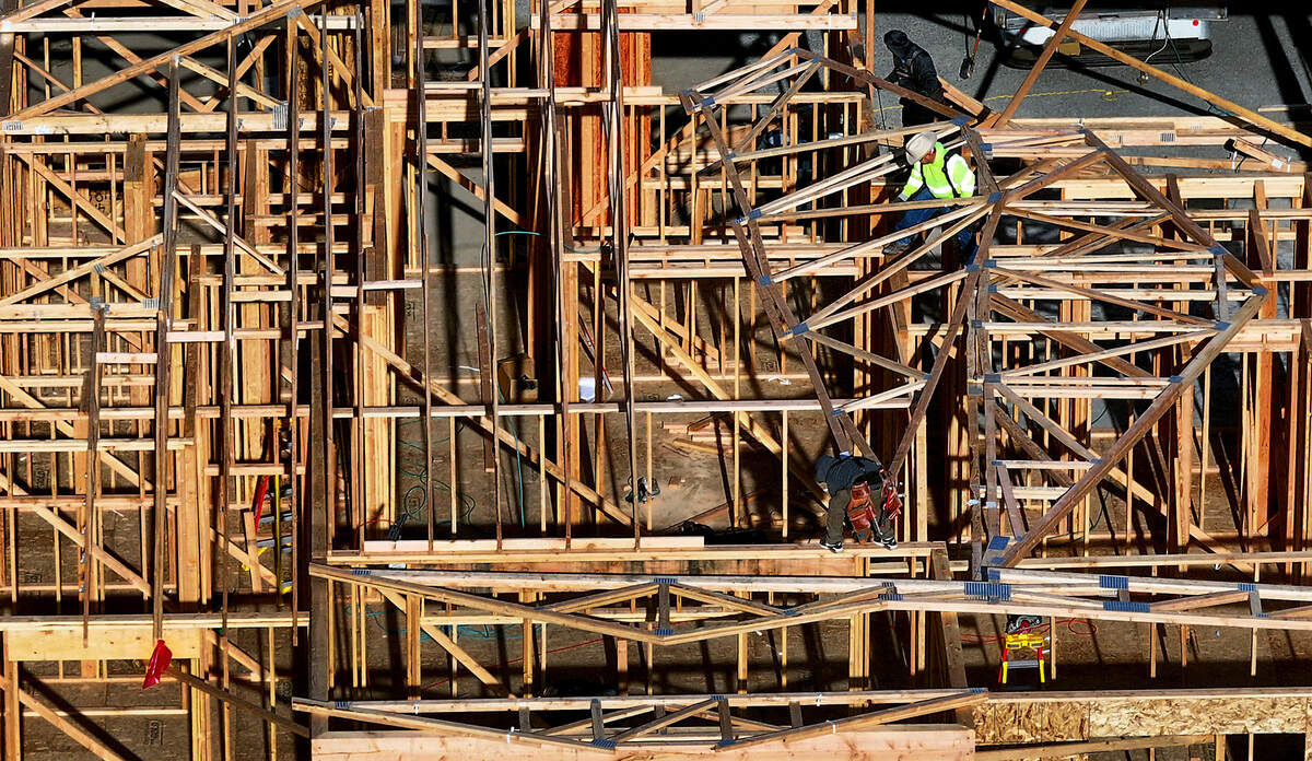 Construction crews lift a roof truss into place for a new home in Quail Ridge at the Horn Rapids in Richland. New tariffs announced by President Trump are expected to add to the cost of a new home and slow the pace of building in Tri-Cities.