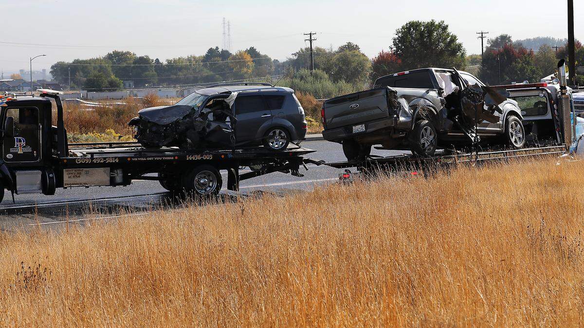 Tow trucks haul away two of the three vehicles involved in Thursday morning's collision on Highway 397 in Kennewick. Two people were injured in the crash.