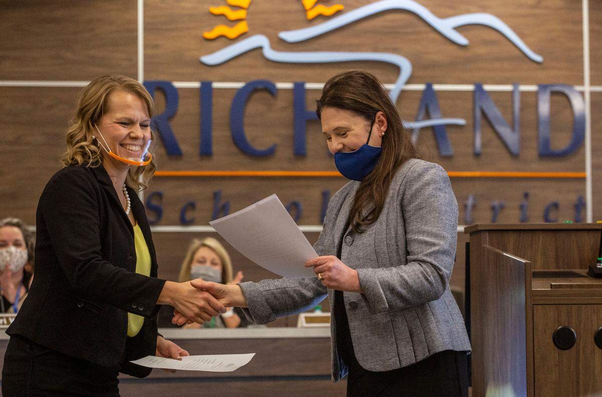 Audra Byrd shakes hands with district Superintendent Shelley Redinger after Byrd was sworn in as a new Richland School Board member in November.
