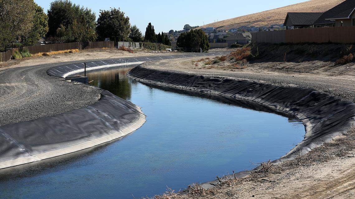 A lined second of the Kennewick Irrigation District's main irrigation canal is visible from South Ely Street winding behind homes near West 40th Avenue in Kennewick.