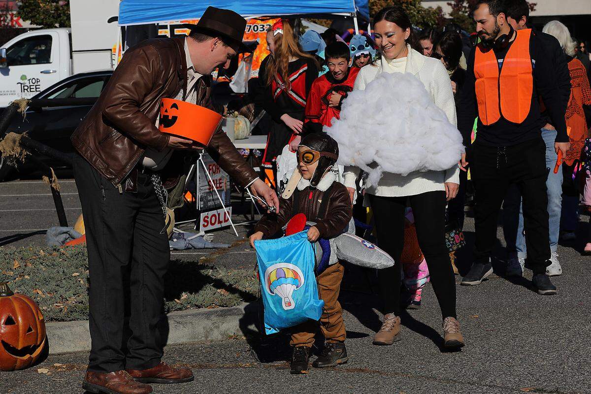 Indiana Jones, also known as insurance agent Tyler Swarner, hands candy to Jason Mukhametzianova, 4, during the Big Bro Joe Foundation’s 4th annual Trunk Or Treat on Sunday outside the Toyota Center in Kennewick. Organizer Joe Thornton said he expected about 1,800. The young pilot was with his parents Irina and David Mukhametzianova of Richland.
