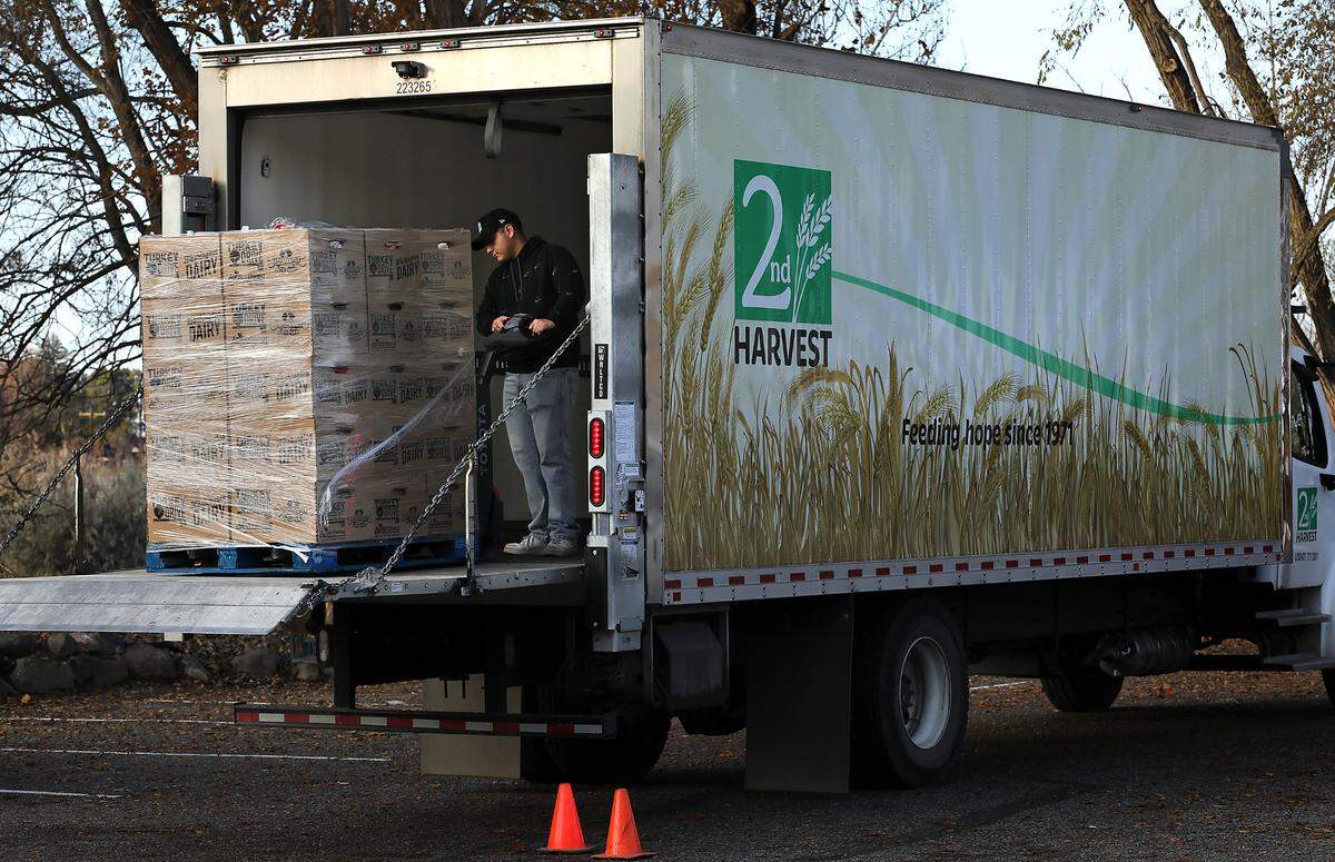 Alonso Murillo unloads pallets of boxed meals before the start of Tuesday’s 2nd Harvest Turkey Drive turkey dinner distribution. Tri-City families pre-registered to receive 230 complete Thanksgiving meals.