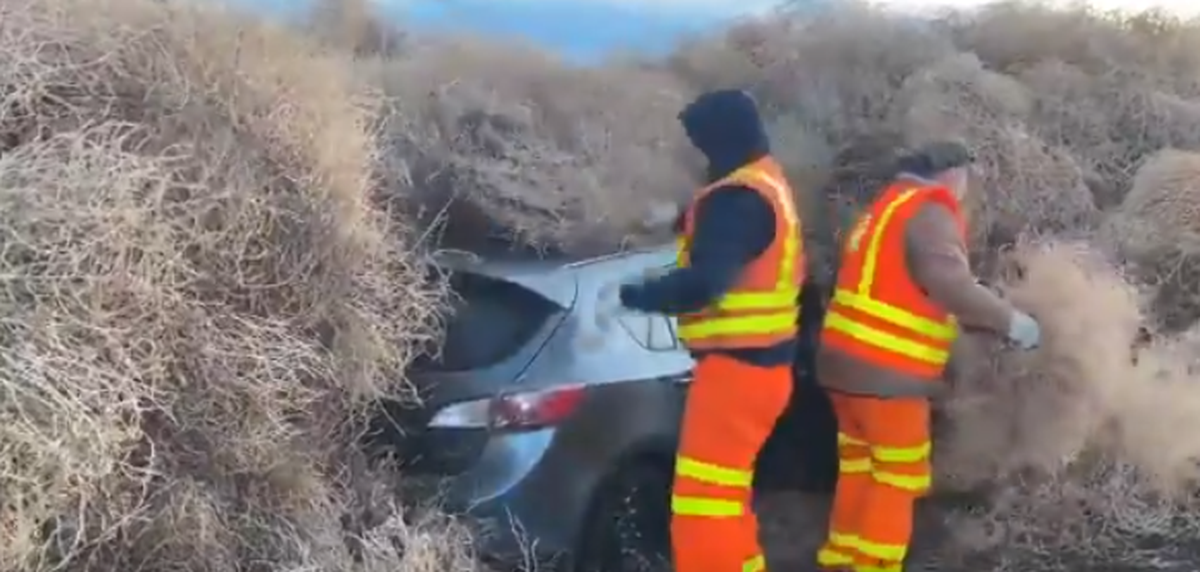 Washington state Department of Transportation workers unburied a car Wednesday morning that had been abandoned New Years Eve along Highway 240 as wind blew thousands of tumbleweeds across the roadway.