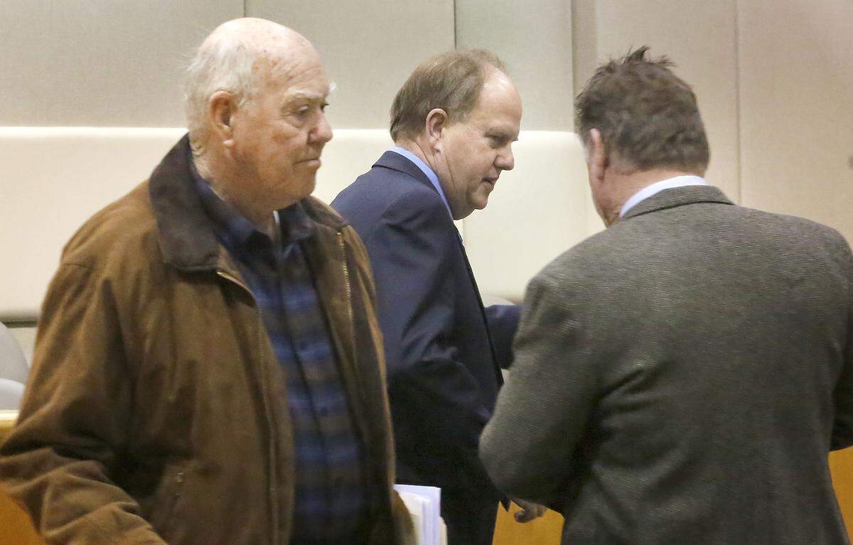 Kennewick Mayor Don Britain, middle, confers with his attorney, Bob Thompson, before the start of Wednesday morning’s hearing in his petition recall. Jerry Martin, who supports the recall effort, walks into the Benton County Superior Court for the hearing. Watch a video at: tricityherald.com/videos