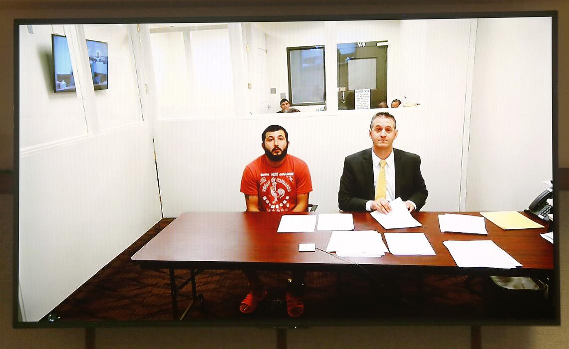 Efrain Gonzalez, 26, makes his preliminary appearance via a video link in Franklin County Superior Court with attorney Michael Quillen, right.